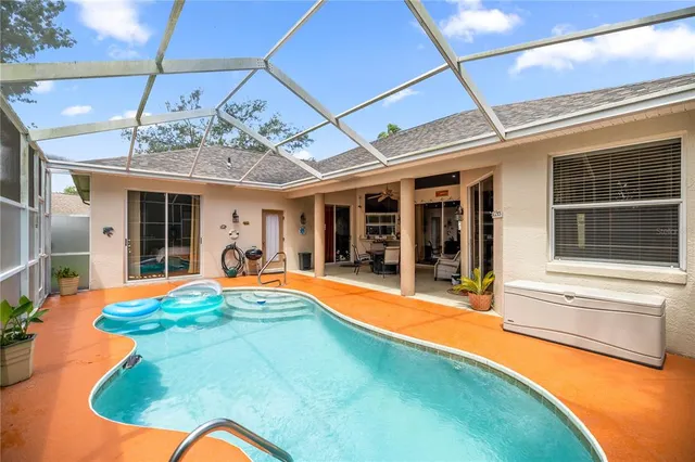 a swimming pool with an outdoor seating and yard
