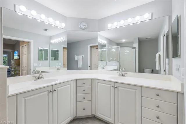 a spacious bathroom with a double vanity sink and mirror
