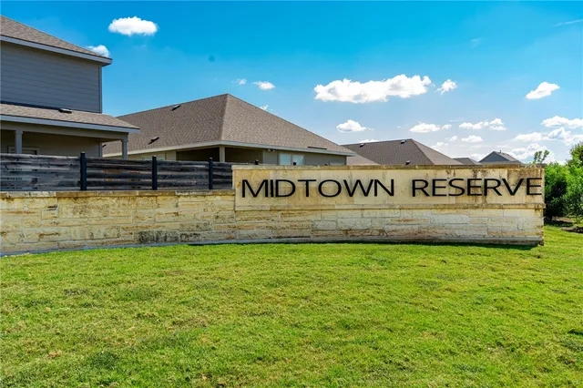 a view of a sign board with yard