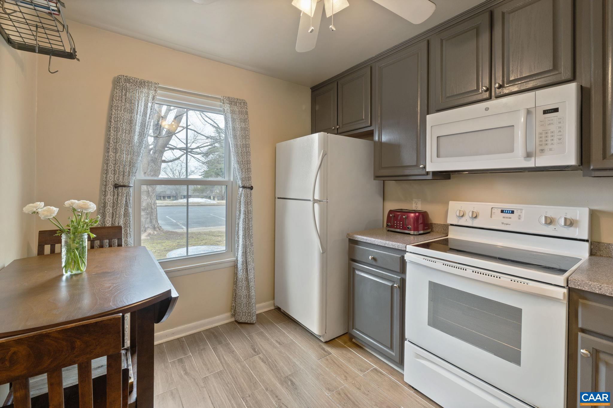 782 Merion Greene Charlottesville, VA 22901 - Photo 11 of 32 a kitchen with granite countertop a refrigerator a stove a sink and dishwasher with wooden floor