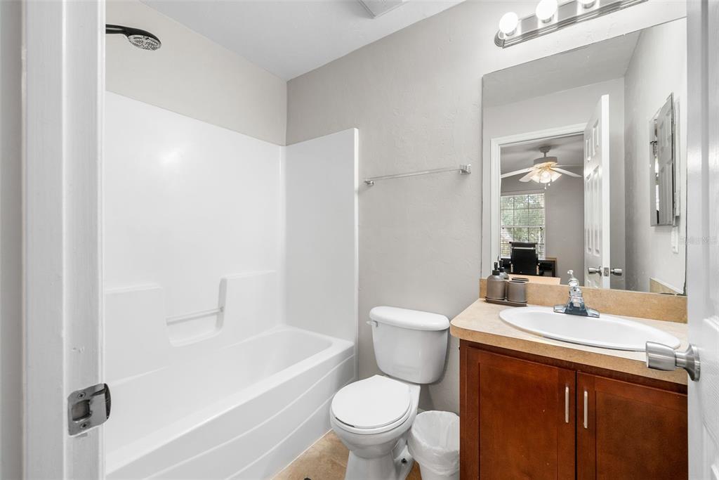 2927 Southwest 35th Place, Unit 113 Gainesville, FL 32608 - Photo 18 of 27 a bathroom with a sink a toilet and shower