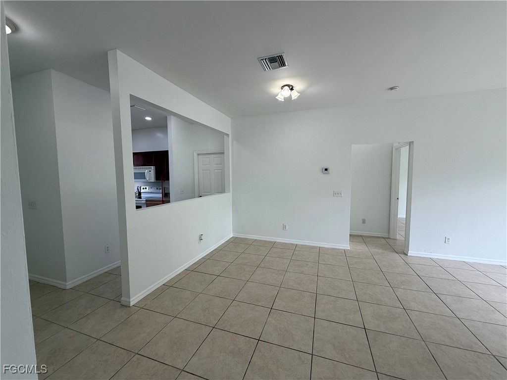 3969 Sunset Road Lehigh Acres, FL 33971 - Photo 11 of 29 an empty room with white walls