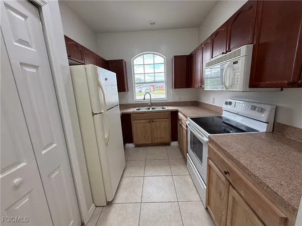 a kitchen with a refrigerator sink and window