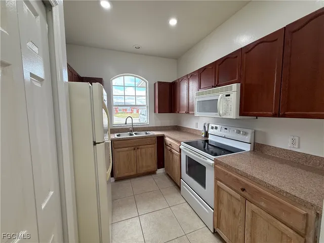 a kitchen with a sink a stove and cabinets