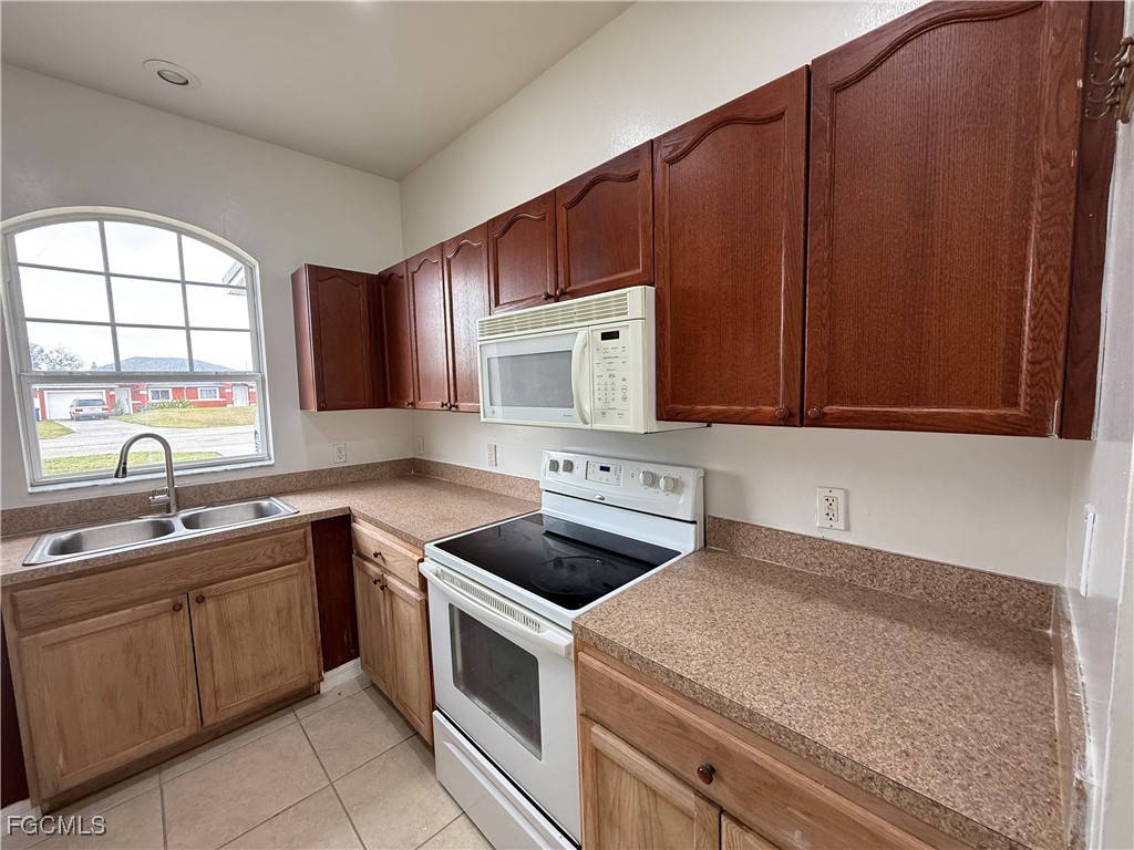 3969 Sunset Road Lehigh Acres, FL 33971 - Photo 15 of 29 a kitchen with a sink and cabinets