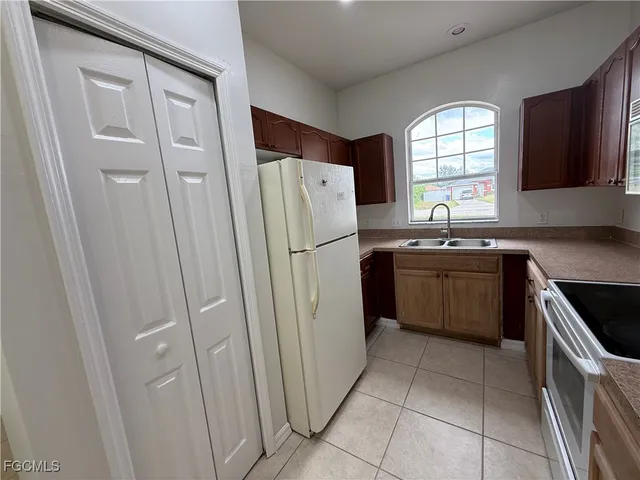 a kitchen with a refrigerator sink and window