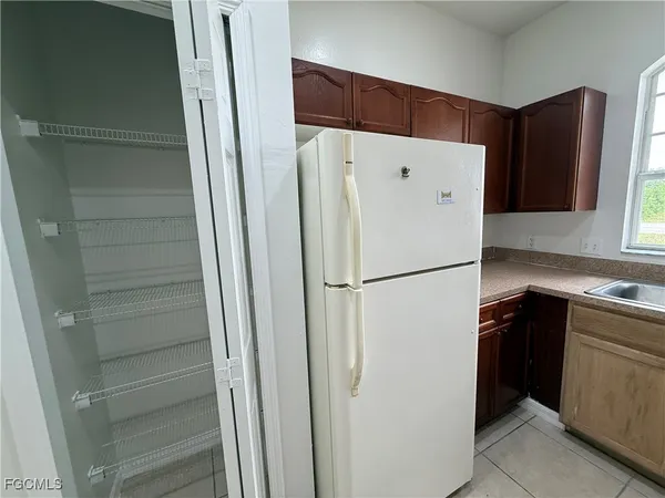 a white refrigerator freezer sitting in a kitchen