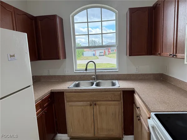 a kitchen with a sink cabinets and window