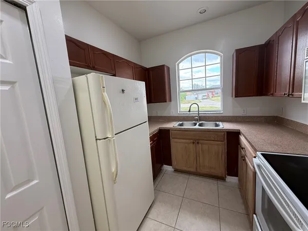 a kitchen with a refrigerator and a sink
