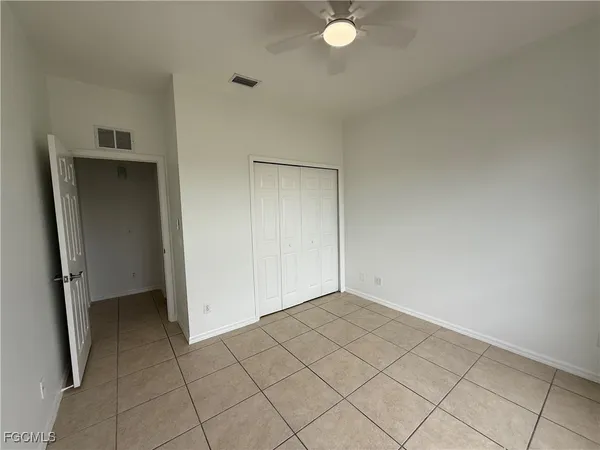 an empty room with a door and mirror