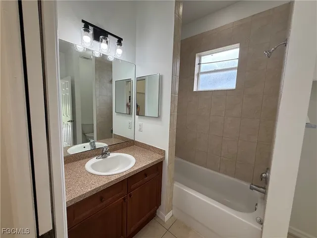 a bathroom with a sink vanity tub and shower