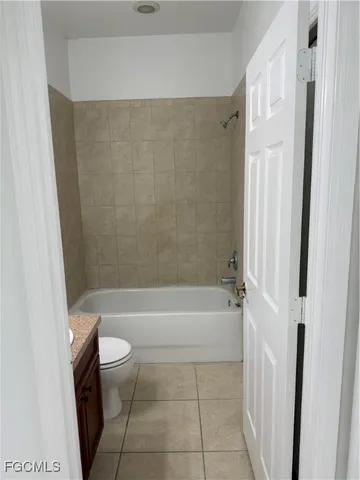 a bathroom with a bathtub shower and toilet