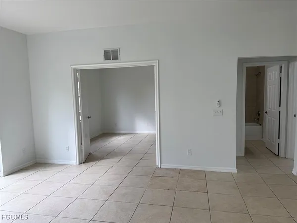 a view of an empty room and closet area