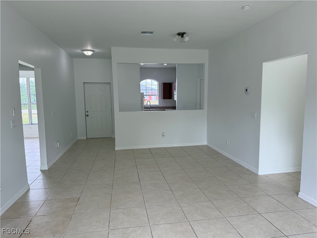 3969 Sunset Road Lehigh Acres, FL 33971 - Photo 9 of 29 an empty room with white walls and windows