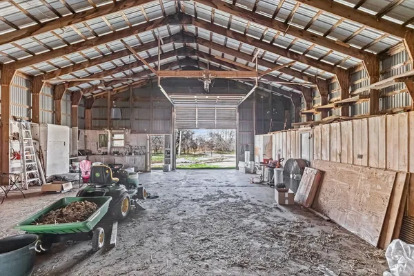 a view of a dining room with furniture and a chandelier
