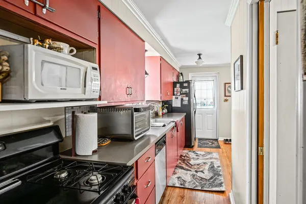 a kitchen with a stove a sink and a refrigerator