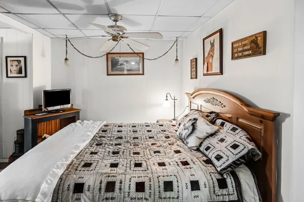 a bedroom with furniture and a wooden floor
