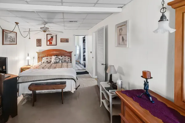 a bathroom with a granite countertop sink a toilet and a mirror
