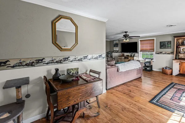a living room with furniture a fireplace and a flat screen tv