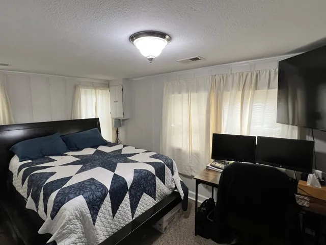 a bedroom with a bed and chair