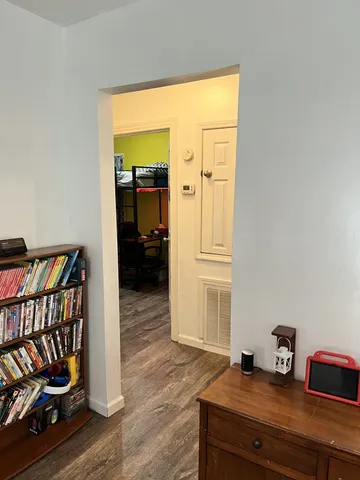 a view of a bedroom with furniture and wooden floor