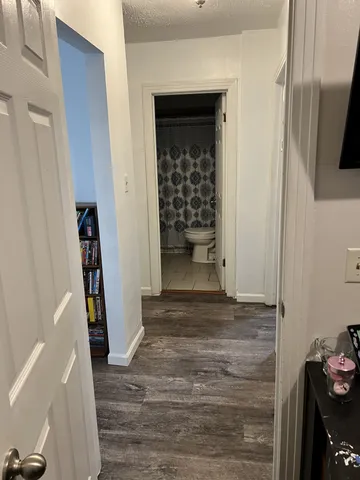 a view of an entryway with wooden floor