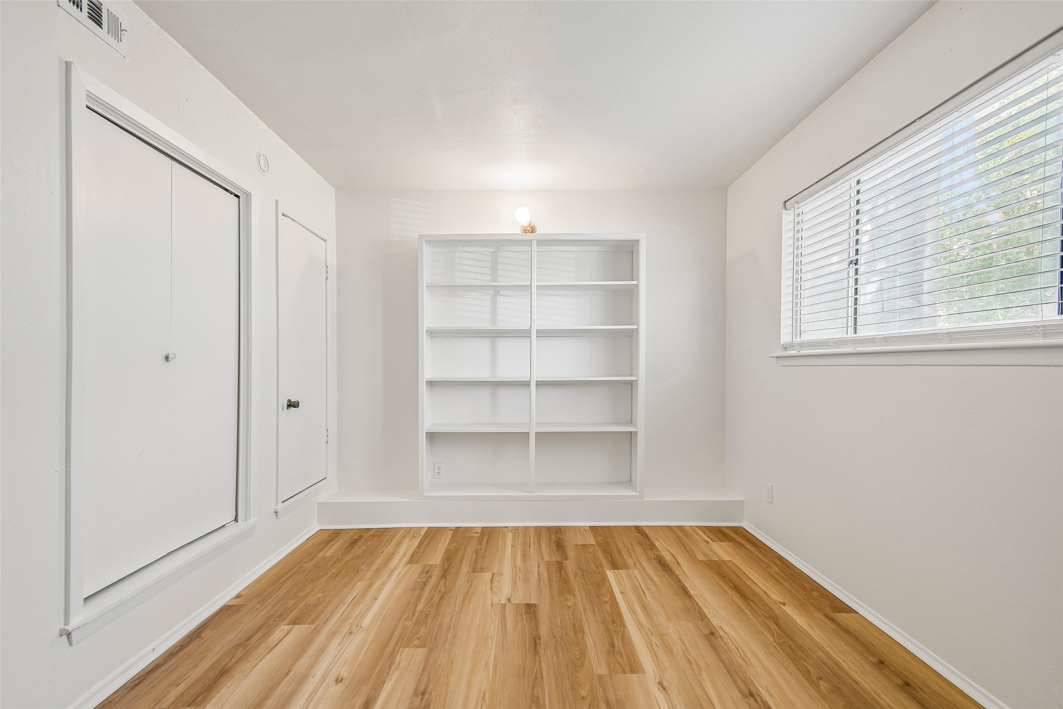 2413 Leon Street, Unit 104 Austin, TX 78705 - Photo 16 of 26 a view of a room with rack on the wall and a window