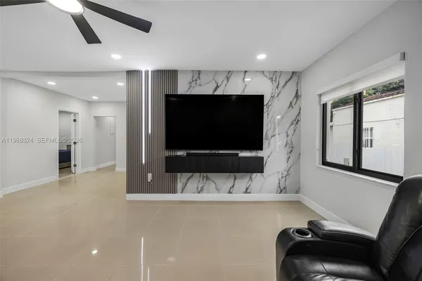 a living room with a flat screen tv and a fireplace