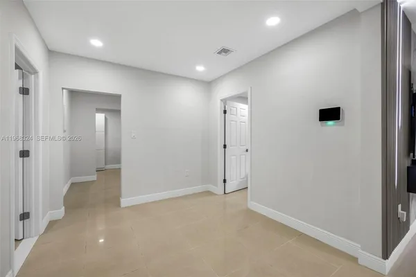 an empty room with closet and mirror