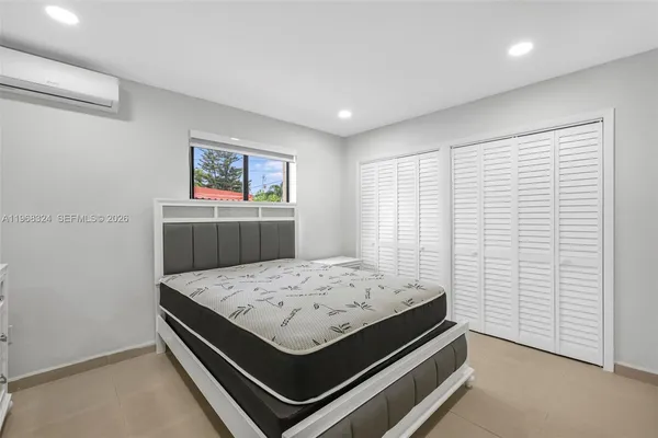 a bed room with a bed and window