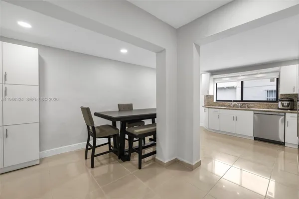 a kitchen with cabinets and chairs
