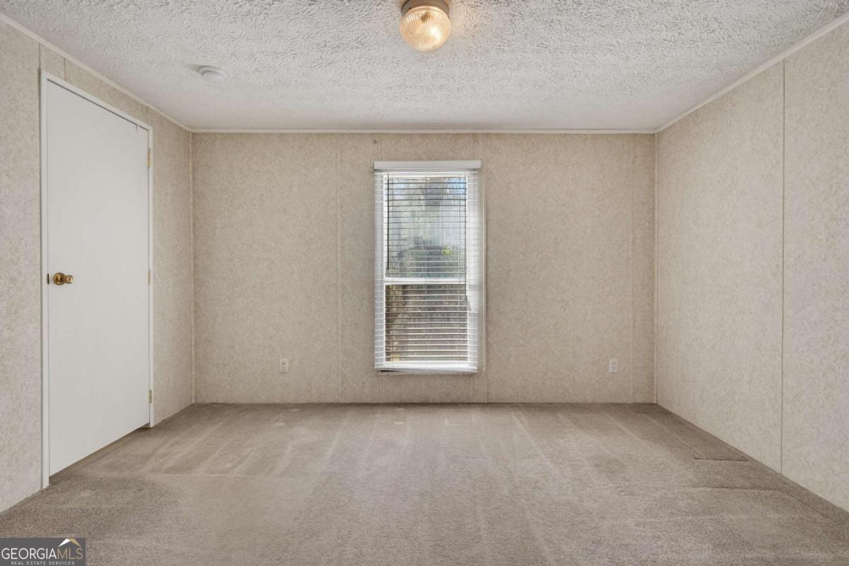 4156 Smiley Road Ludowici, GA 31316 - Photo 12 of 32 a view of an empty room with a window