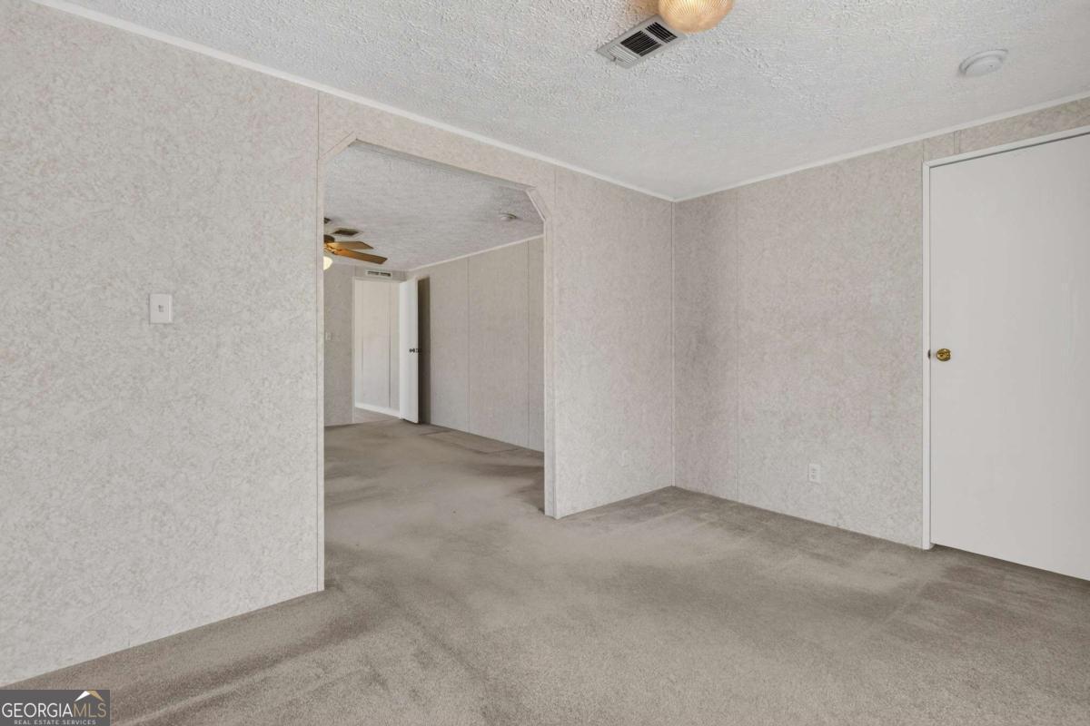 4156 Smiley Road Ludowici, GA 31316 - Photo 13 of 32 a view of an empty room with a window