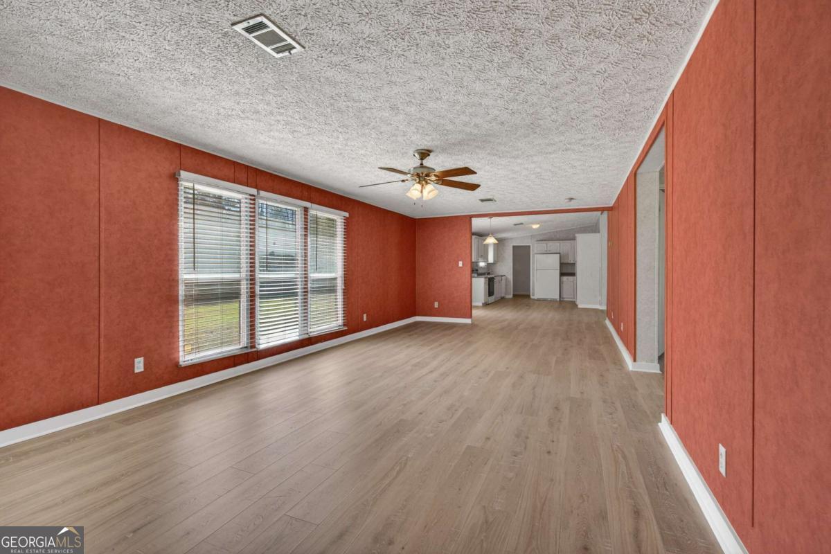 4156 Smiley Road Ludowici, GA 31316 - Photo 24 of 32 wooden floor in an empty room with a window