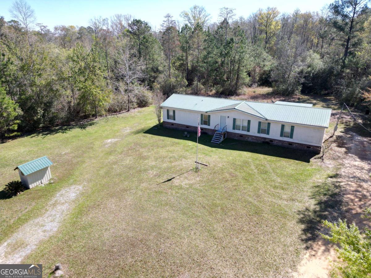 4156 Smiley Road Ludowici, GA 31316 - Photo 30 of 32 a view of a house with a yard and sitting area