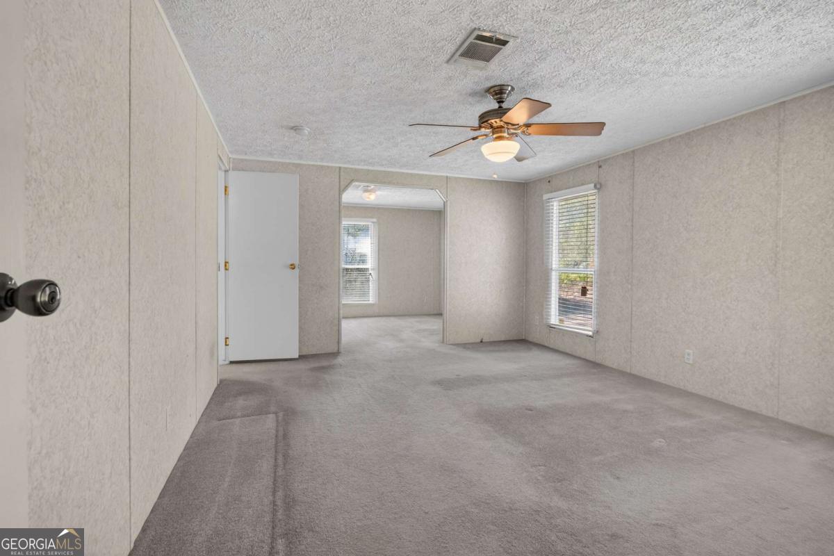 4156 Smiley Road Ludowici, GA 31316 - Photo 3 of 32 an empty room with windows and fan