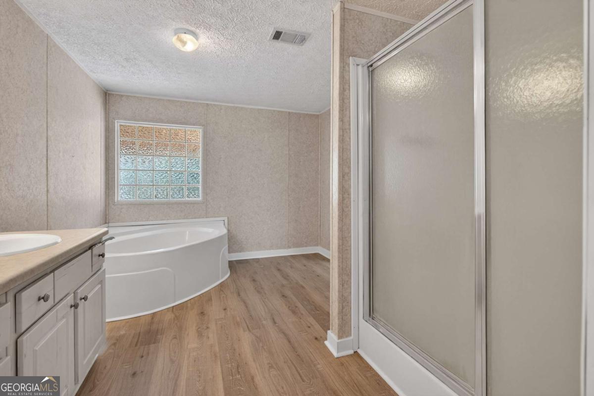 4156 Smiley Road Ludowici, GA 31316 - Photo 5 of 32 a bathroom with a tub shower and sink