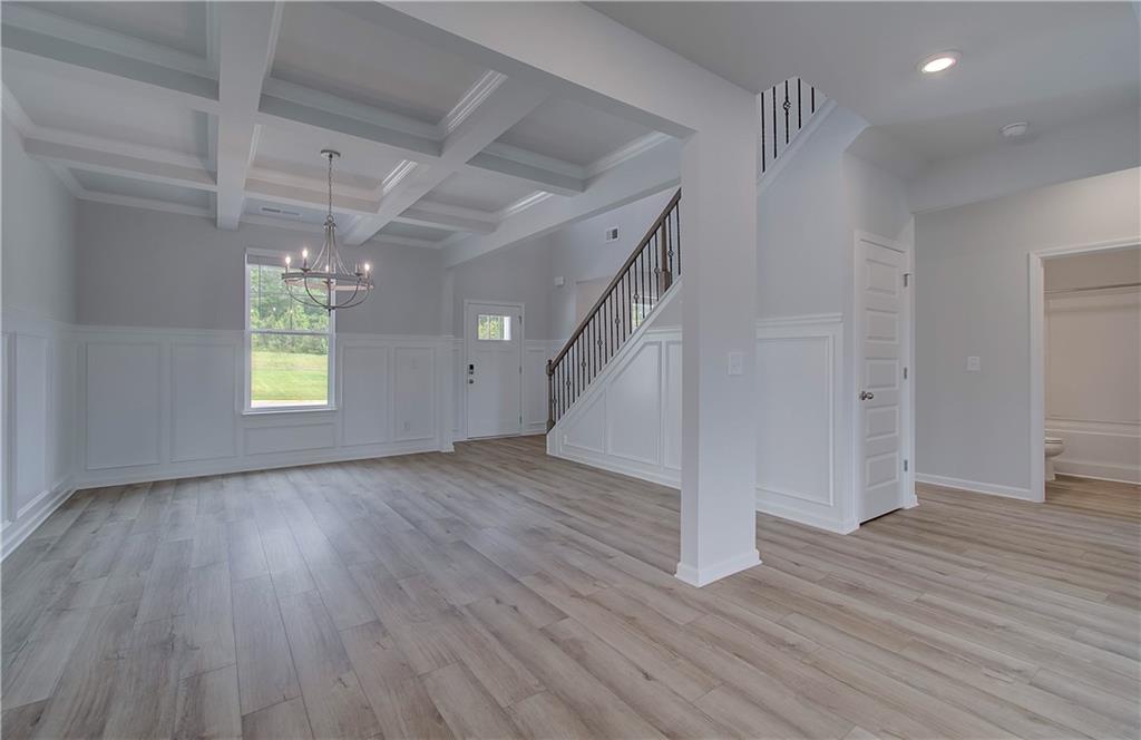 108 Felicity Pike Locust Grove, GA 30248 - Photo 9 of 37 an empty room with wooden floor and windows