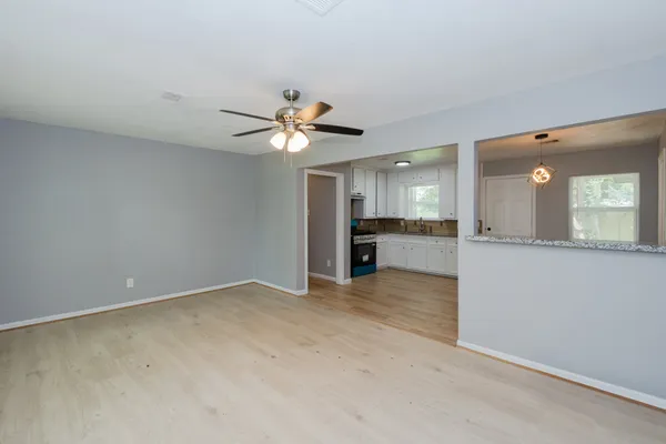 an empty room with a kitchen and a sink