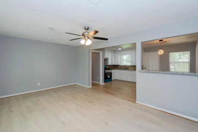 an empty room with a kitchen and a sink