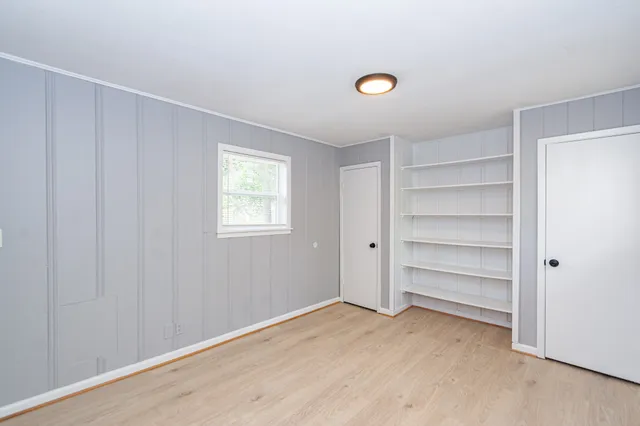 a view of an empty room with a closet