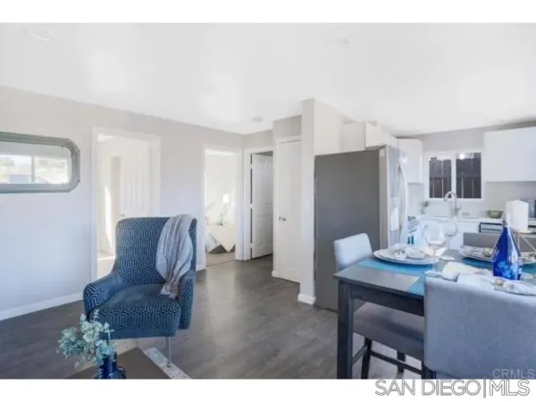 a view of kitchen with stainless steel appliances furniture refrigerator and dining table