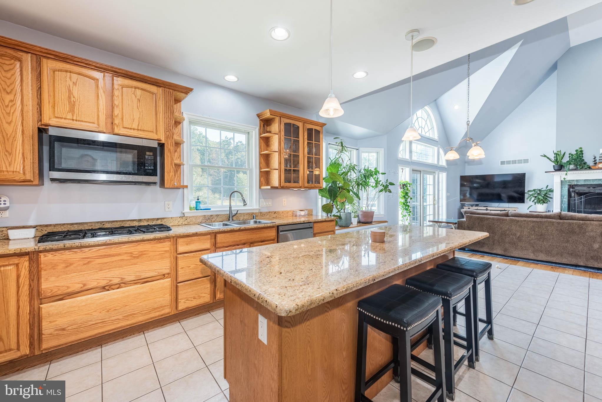 2623 Urey Road White Hall, MD 21161 - Photo 11 of 60 a kitchen with granite countertop a stove a sink and a microwave