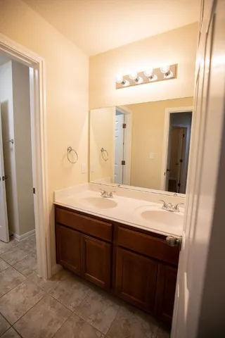a bathroom with a double vanity sink and mirror
