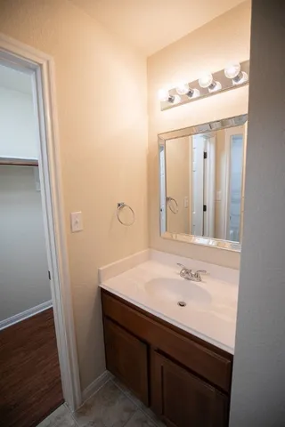 a bathroom with a sink a mirror and vanity