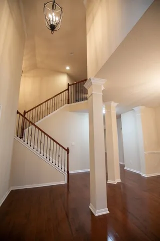 a view of entryway and hall with wooden floor