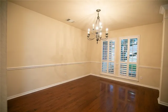 a view of a livingroom with wooden floor and a window