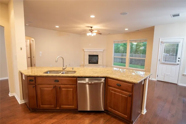 a kitchen with a sink and wooden floor
