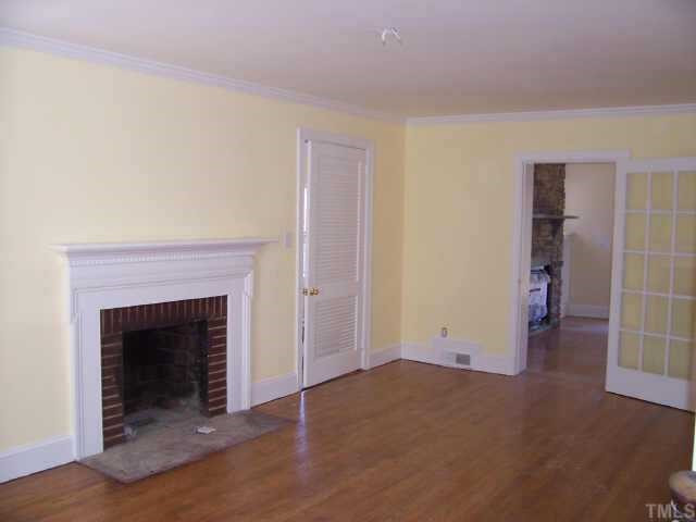 813 Chamberlain Street Raleigh, NC 27607 - Photo 3 of 9 Living room with masonry woodburning fireplace and beautiful refinished hardwood floors. Other