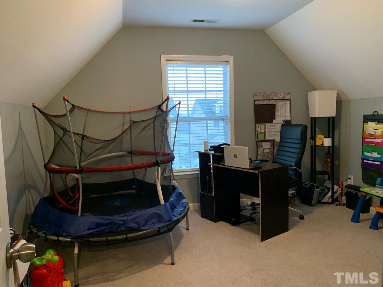 1422 Infinity Lane Raleigh, NC 27610 - Photo 12 of 16 a room with furniture and a flat screen tv